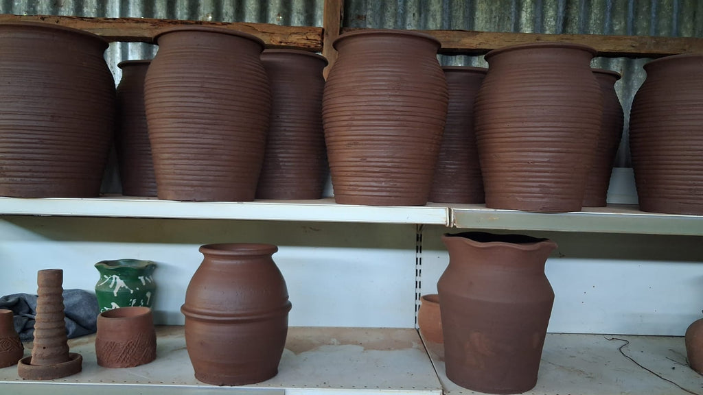 Large ribbed terracotta clay urns side view