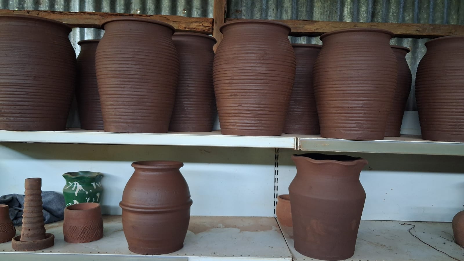 Large ribbed terracotta clay urns side view