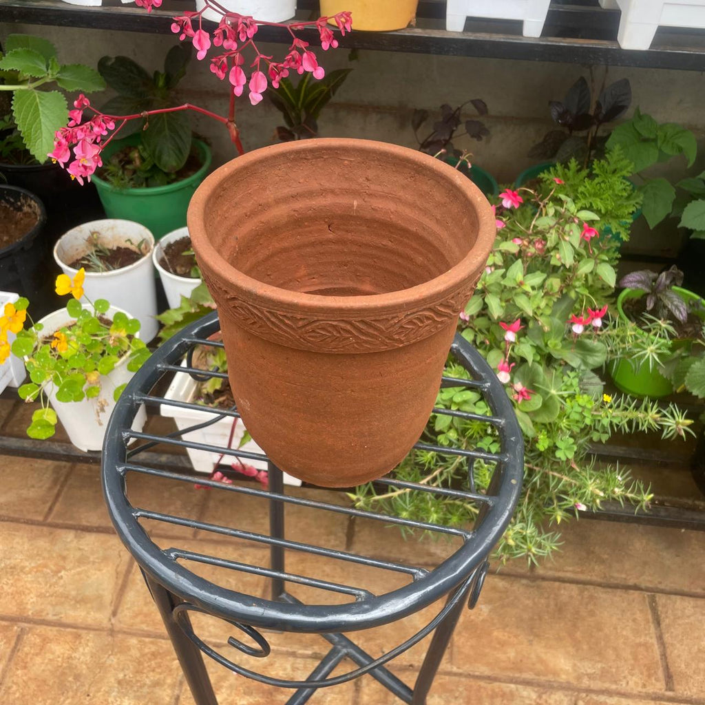 Side view of empty terracotta-coloured clay plant pot