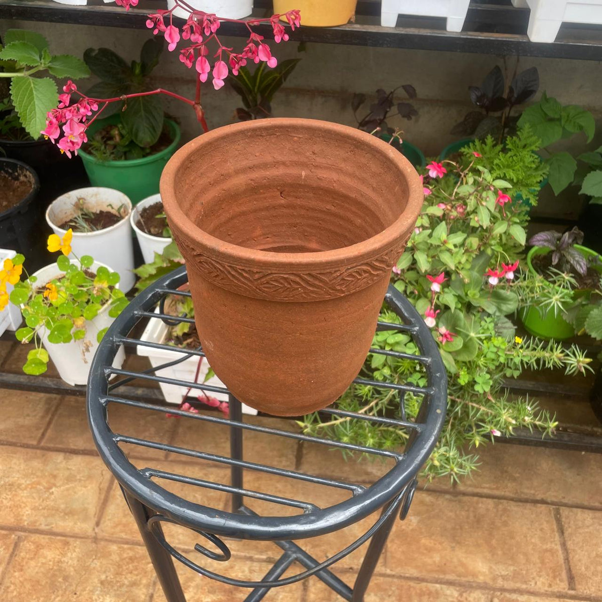 Side view of empty terracotta-coloured clay plant pot