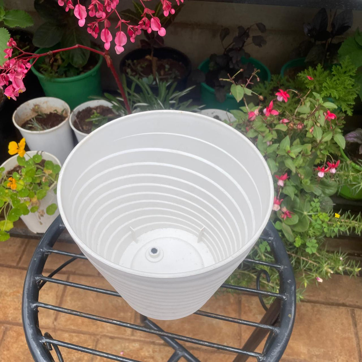 Inside view of white ribbed plant pot showing drainage hole