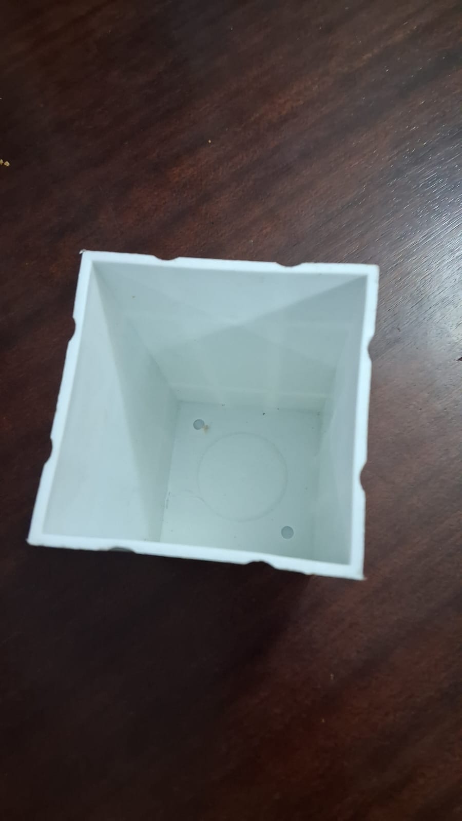 Actual empty white square pot viewed from above